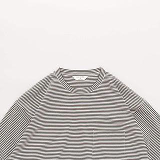 Détail du col et des manches du t-shirt à rayures blanc et olive de Still By Hand, modèle de la collection SS25