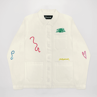 Veste brodée 'Gribouillages' d'Encré en beige, mettant en avant un design graphique avec des broderies colorées. Parfaite pour un style casual.