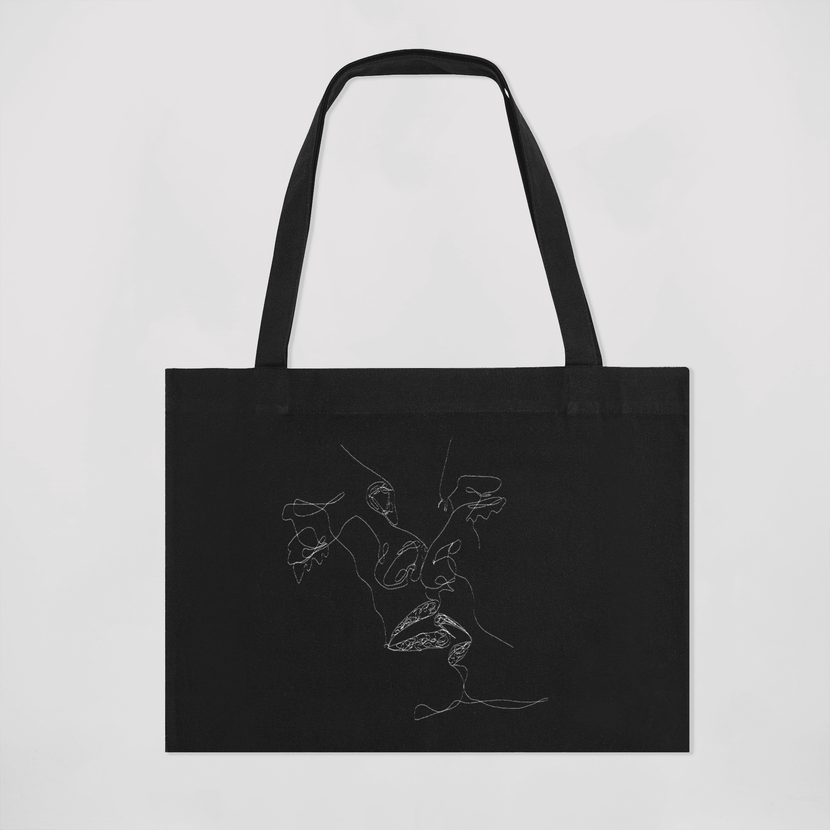 Sac tote noir L'âme réveuse d'Encré, mettant en avant une broderie artistique élégante sur le devant, parfait pour allier style et praticité.