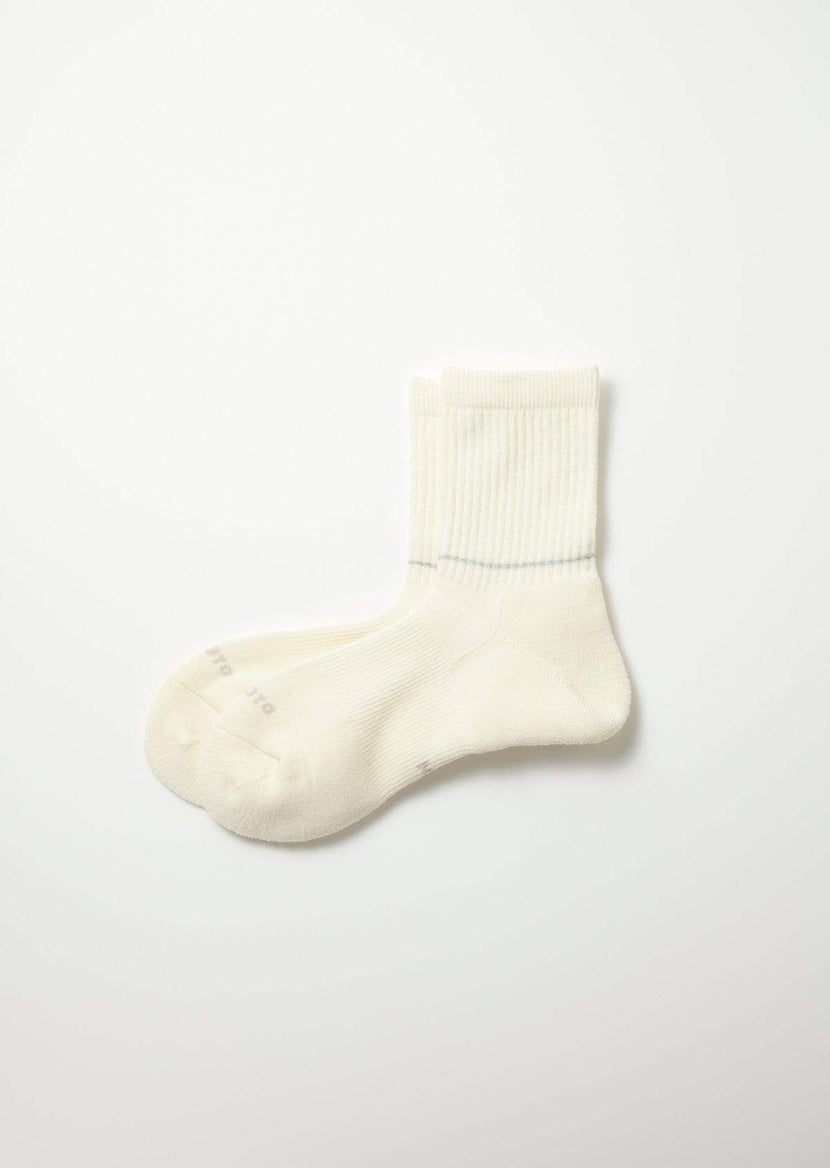 Chaussettes Off White de Rototo, modèle R1483, en laine Mérinos avec des détails réfléchissants, idéales pour diverses activités extérieures et urbaines.